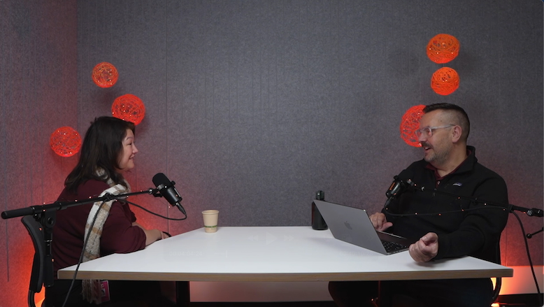 Two people talking during a podcast recording